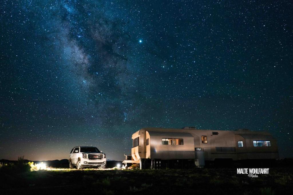 a truck and a camper at night under the stars at Stargazer, AC, Heat, Free firewood, ice cream, bottled water and smores in Williams