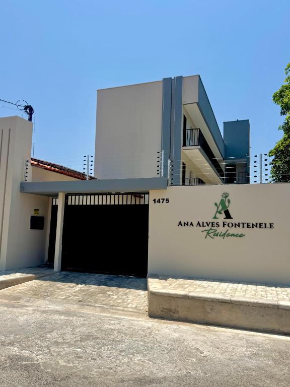 a building with a gate in front of a building at Flats Ana Alves Residence Delta do Parnaíba- Piauí in Parnaíba