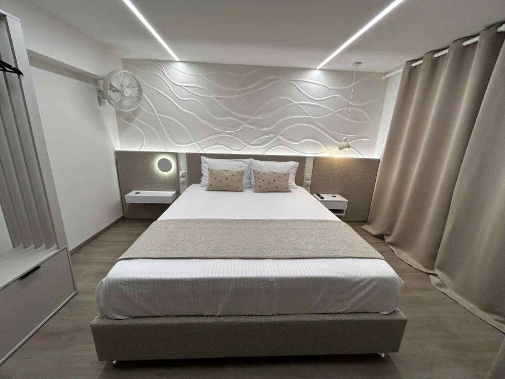 a bedroom with a large bed in a room at ANAVASI Loft SUITE in Alexandroupoli