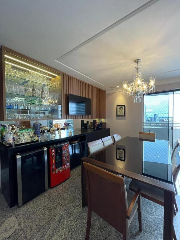 a restaurant with a bar with a table and chairs at Luxury Umarizal Accommodation COP30 in Belém