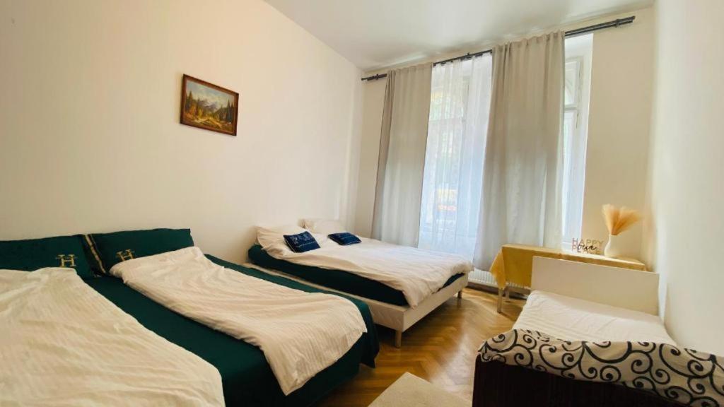 a bedroom with two beds and a window at Private room in the Centre in Prague