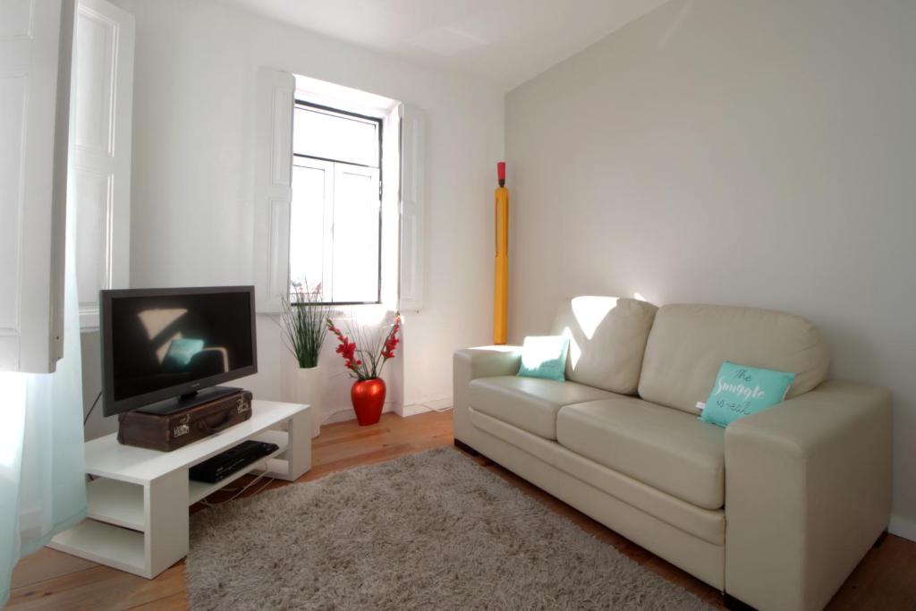 リスボンにあるRita & Marino Apartmentのリビングルーム(白いソファ、テレビ付)