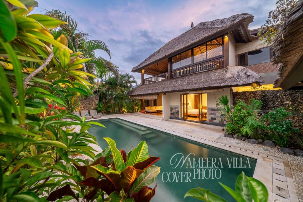 una casa con piscina delante de ella en Nameera Villa, en Seminyak