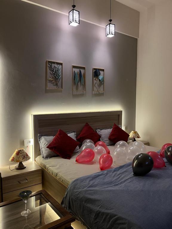 a bedroom with two beds with balloons on it at Stay Heights near Expo mart in Greater Noida