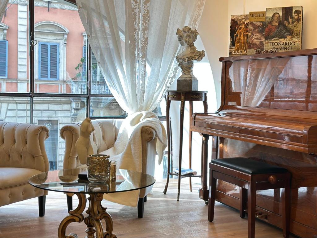 a living room with a piano and a table at Trevi Fountain Elegant Suites by Marianna in Rome