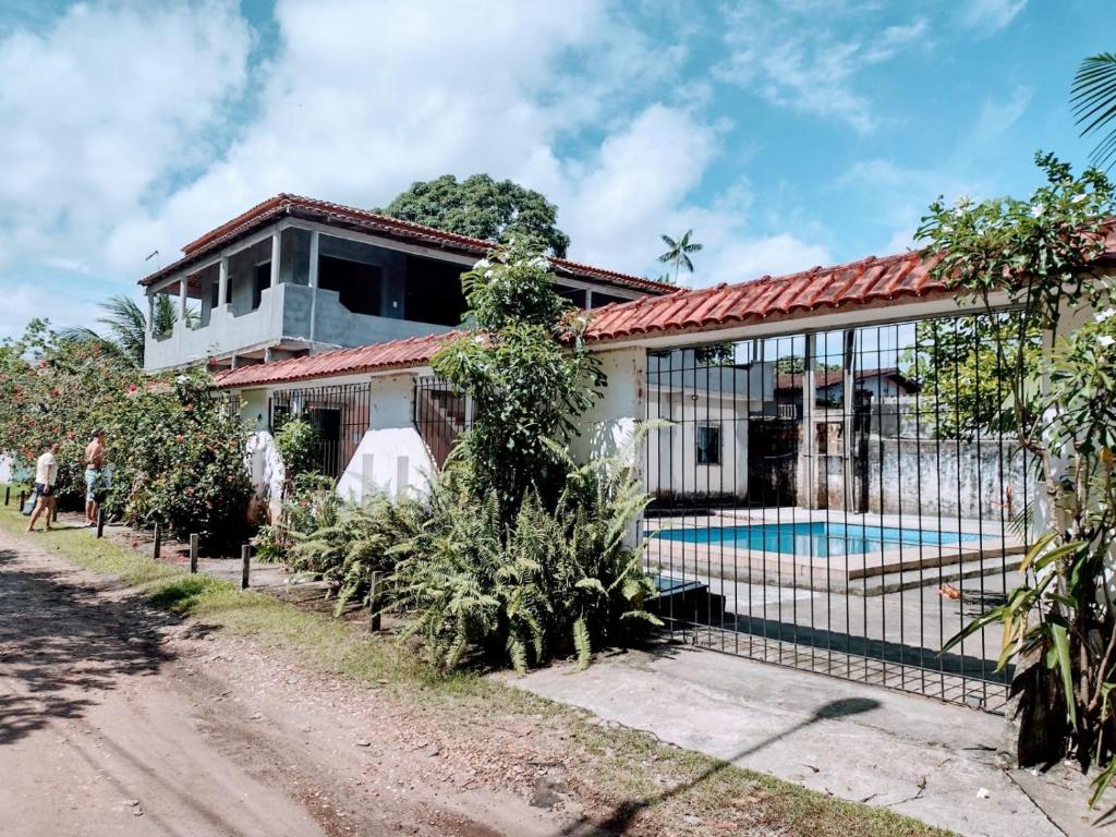 a house with a swimming pool in front of it at Casa Ariramba - Your place in COP30 in Belém