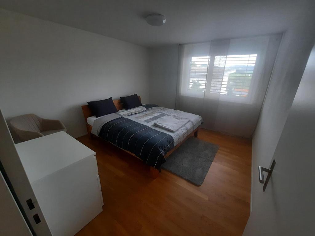 a small bedroom with a bed and a window at Zimmer 1, Haus der Begegnung in Goldingen