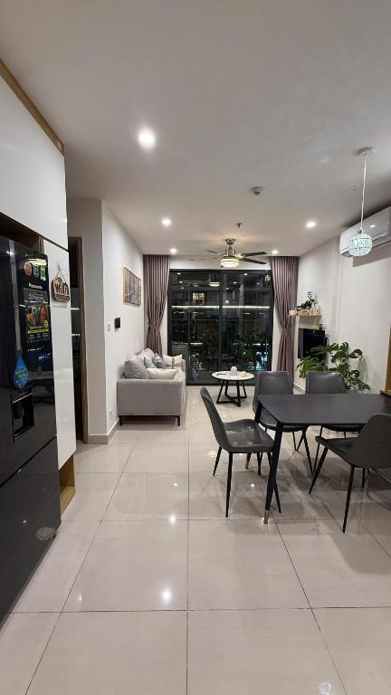 a living room with a table and chairs and a couch at Moon Homestay 0308 in Gia Lâm Pho