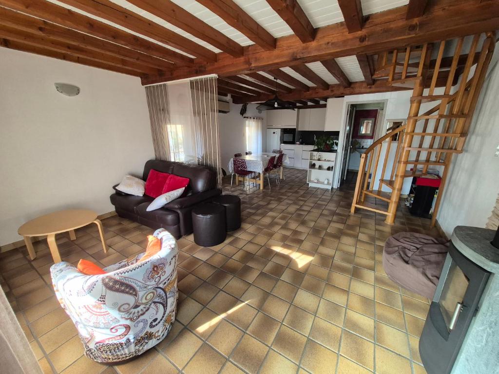 a living room with a couch and a table at Maison cozy dans les Volcans in Sayat