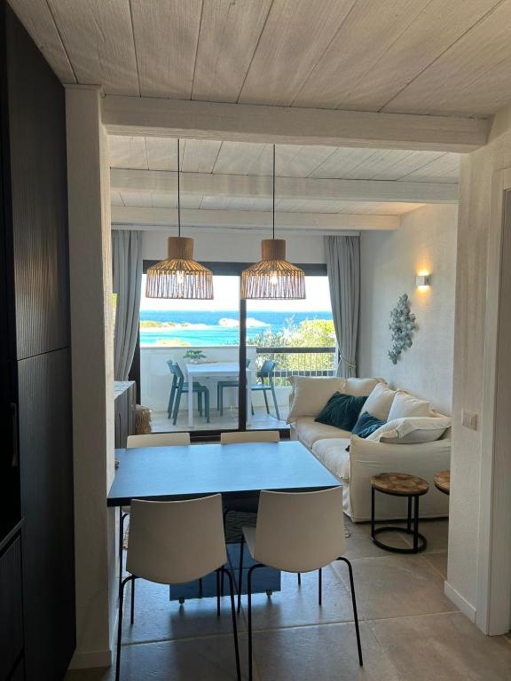 a living room with a blue table and a couch at TheView108, Rena Bianca in Baja Sardinia