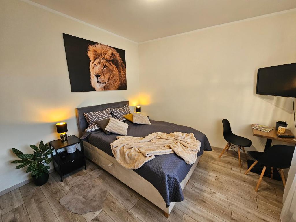 a bedroom with a bed with a lion picture on the wall at Jannseni Apartment in Pärnu