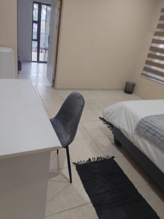 a bedroom with a desk and a chair next to a bed at Le Caille, St Lucia Two bedroom unit in St Lucia