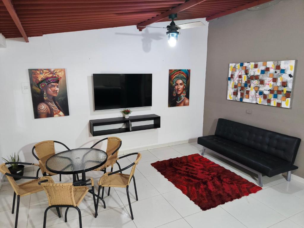 a living room with a black couch and a table at Casa Terraza in El Zaino