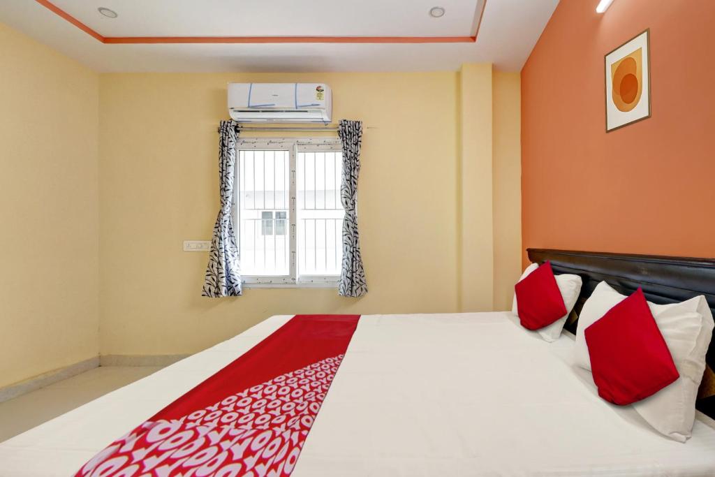 a bedroom with a bed with red pillows and a window at SEA COASTAL INN-3 in Kākināda