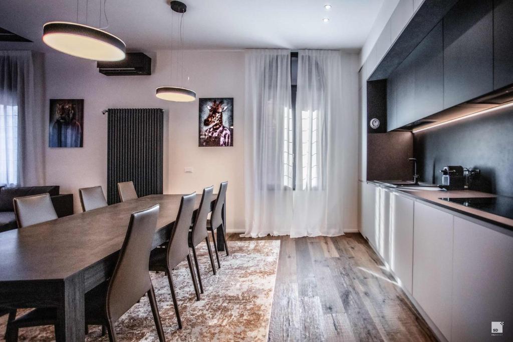 a dining room with a table and chairs at Luxury House In Bologna Marchesana 150 mq in Bologna