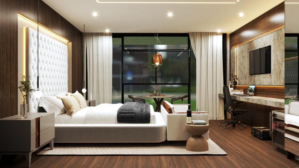 a bedroom with a large white bed and a desk at Tivoli Maiorana Belém Pará Hotel in Belém