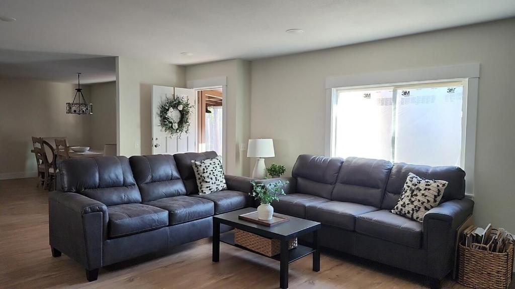 a living room with a couch and a table at Sandy Pacific Hideaway 1 in Florence