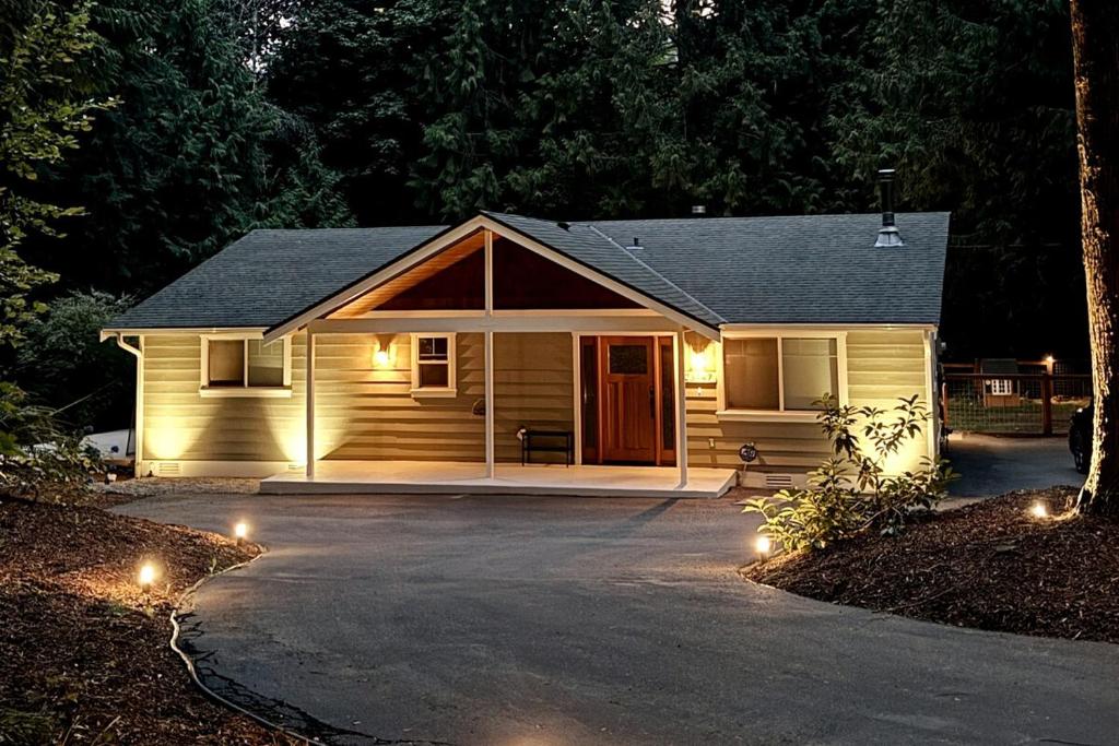 a small house with lights in front of it at The Mossy Nook A Cozy Escape in the Woods! in Issaquah