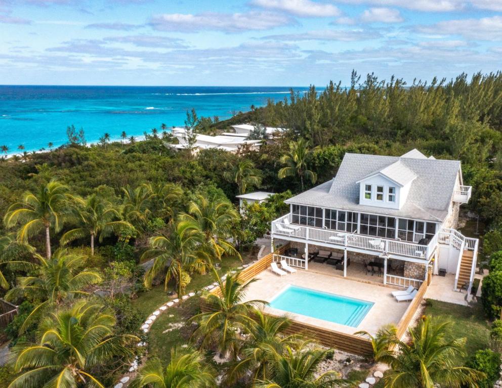 an aerial view of a house with a swimming pool and the ocean at Bahama Mama home in Governorʼs Harbour