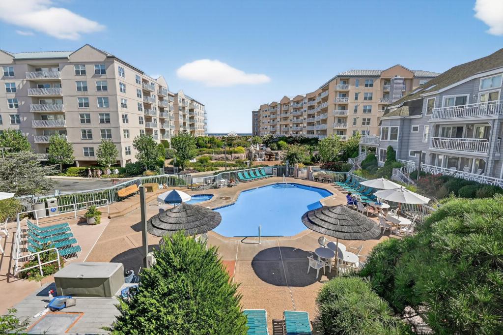 a view of a pool with umbrellas and chairs at Wildwood Crest SeaPointe Village Condo condo in Diamond Beach