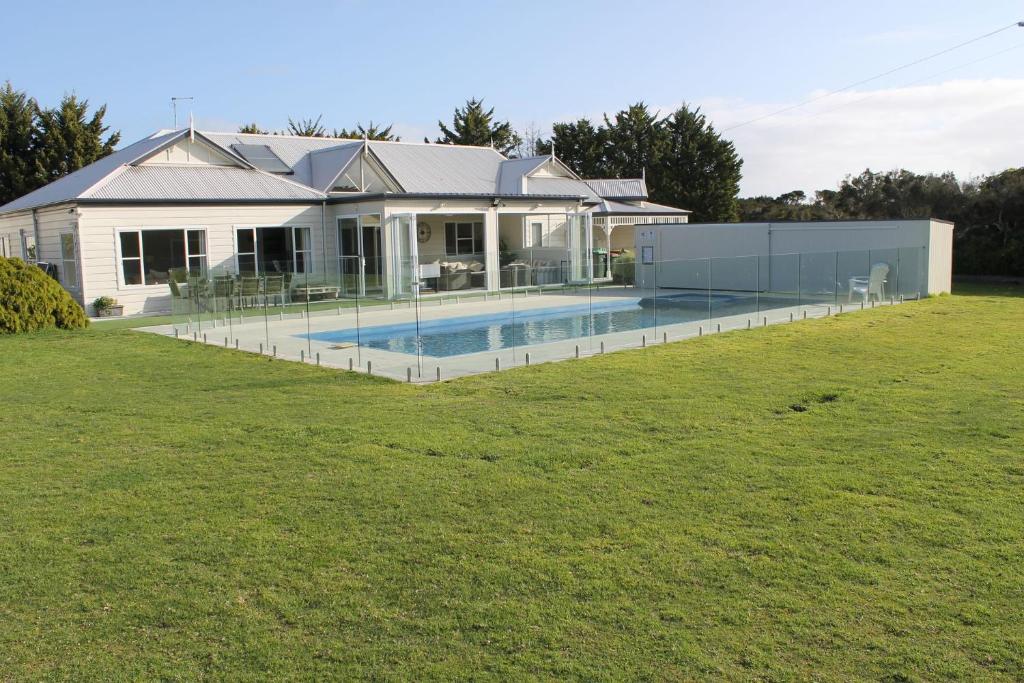 a house with a swimming pool in a yard at Acre's Rest in Ventnor