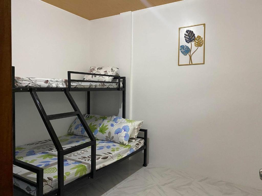 a room with a bunk bed and a shelf at Panglao Transient house close to nature with bonfire in Panglao