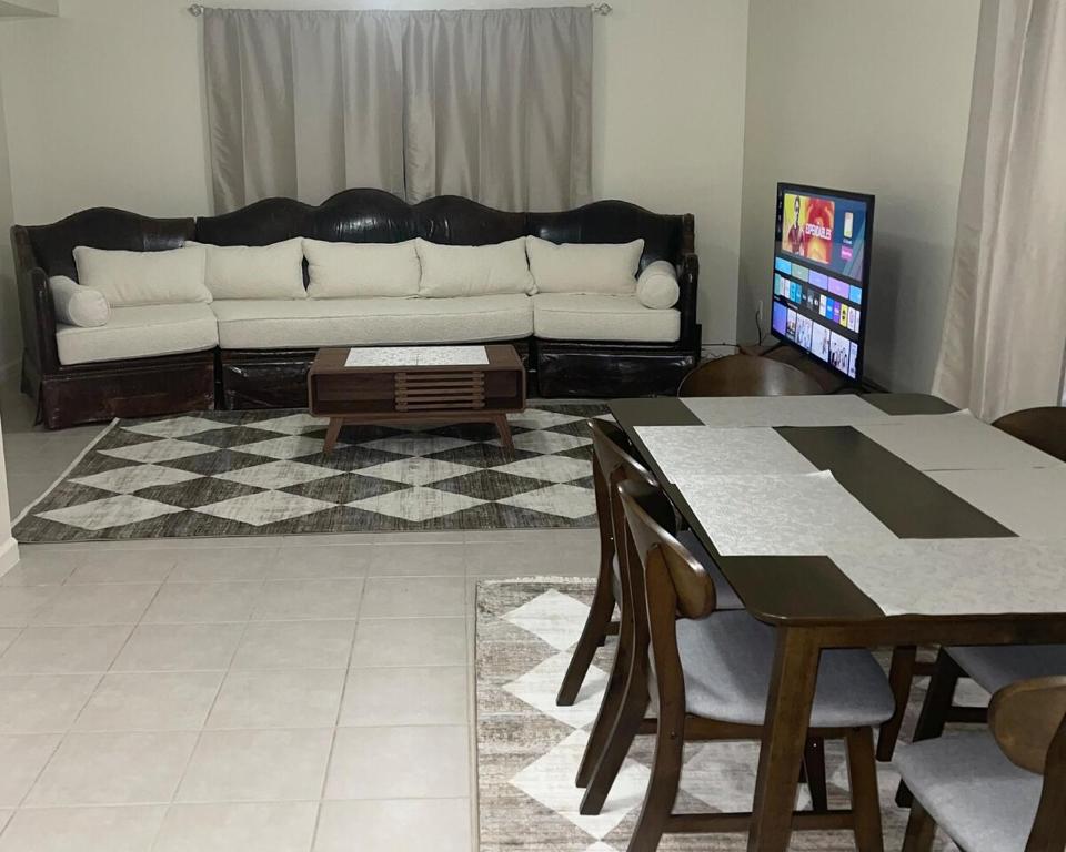 a living room with a couch and a table at Cozy 2 Bedrooms 1and half Bathrooms Near Prudential with Parking Entire Apartment in Newark