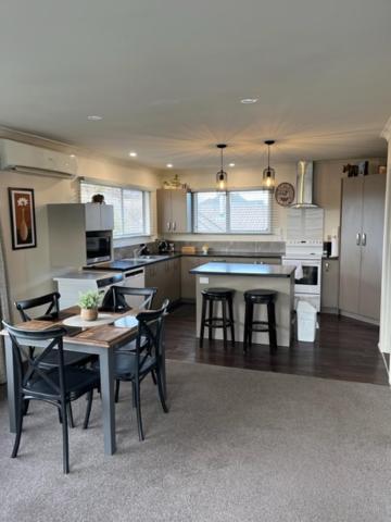 a kitchen and dining room with a table and chairs at Boutique on Russel in Invercargill