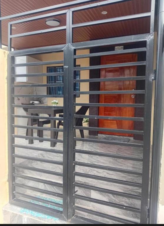 a gate to a horse stall with a table in the background at elisatransienthouse in Labac