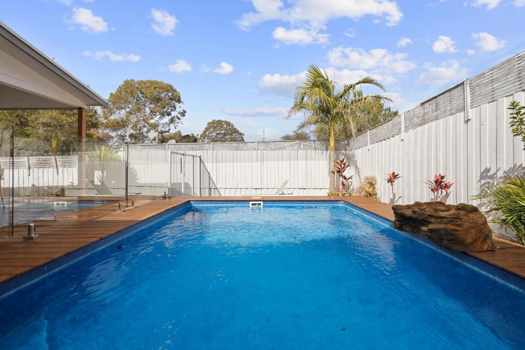 a swimming pool in the backyard of a house at The Palm House - Cowes in Cowes