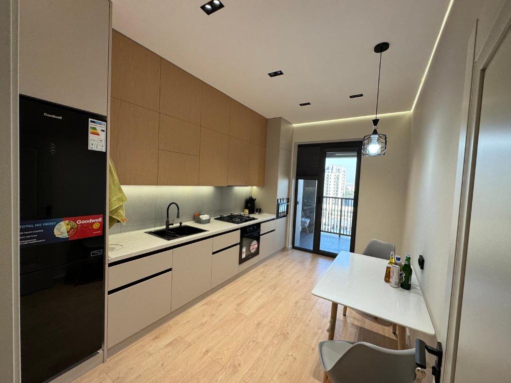 a large kitchen with a table and a refrigerator at Golden House Oz'Makon in Tashkent