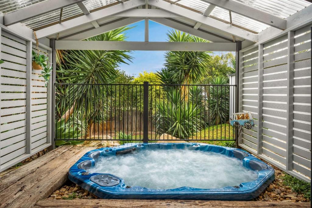 a hot tub on a deck with an open patio at View to the Green in Cowes
