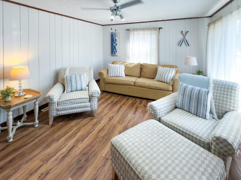 a living room with a couch and chairs and a table at Lake Huron Getaway by arc Vacation Rentals in Lexington