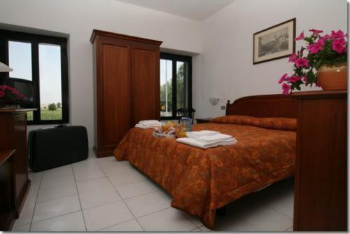 a hotel room with a bed and a television at Hotel Vecchio Convento in Bareggio