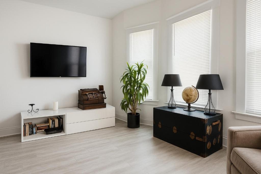 a living room with a flat screen tv on a wall at Spacious 4BR Family Home in Detroit WiFi Parking in Detroit