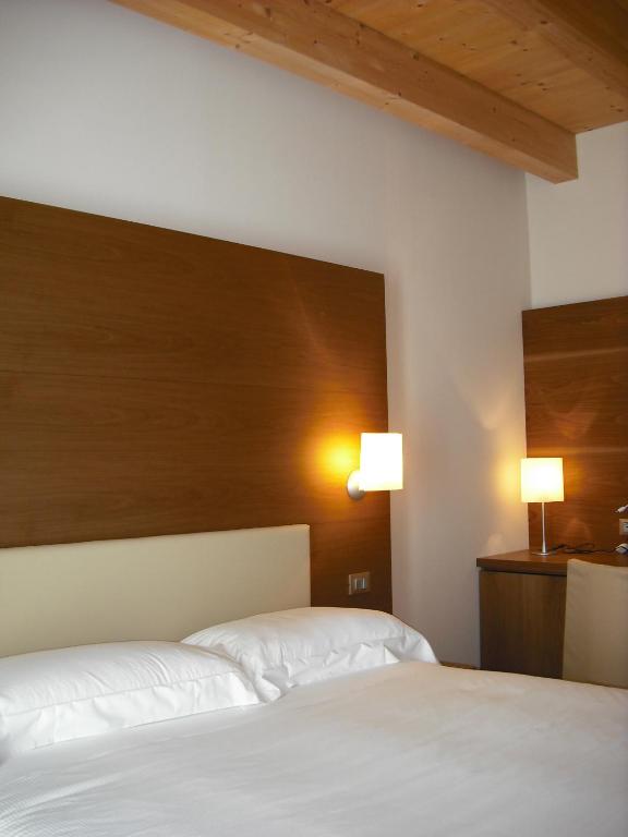 Postel nebo postele na pokoji v ubytování Hotel Operà