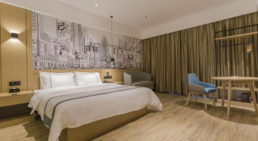 Postel nebo postele na pokoji v ubytování City Comfort Inn Foshan Shishan Square