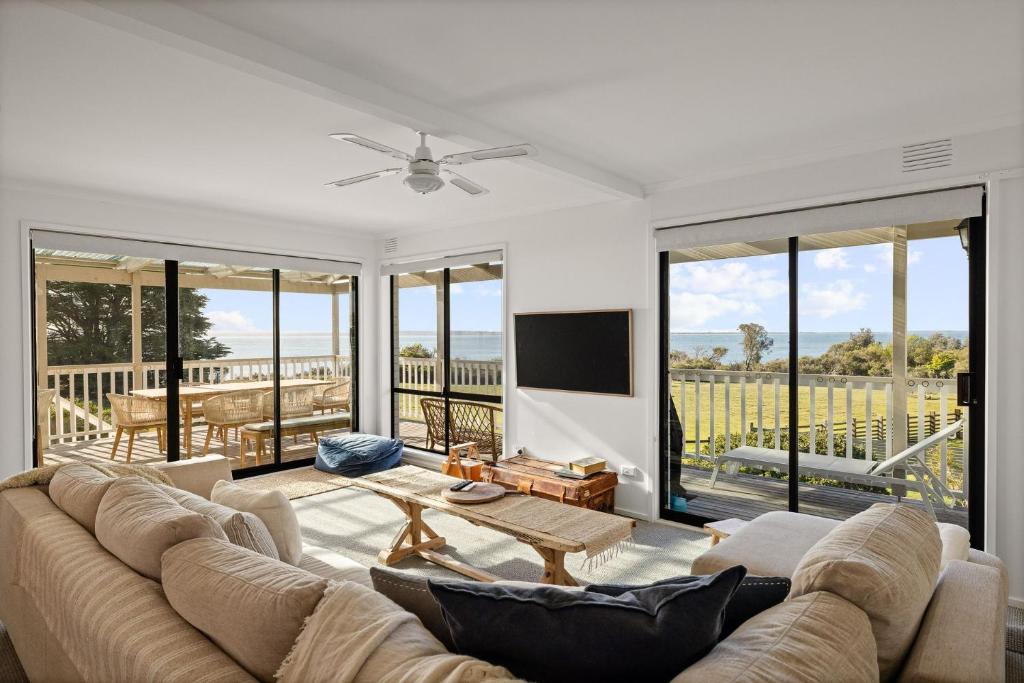 a living room with a couch and a table at Casa Blanca Ventnor Beach in Ventnor
