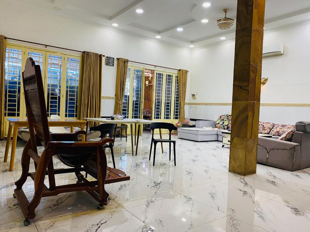a living room with a table and chairs in it at Russian Market Bakery and Guesthouse in Phnom Penh