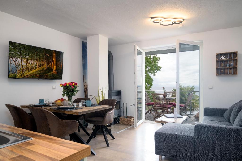 a kitchen and living room with a table and a couch at FeWo Sonnenschein in Sassnitz