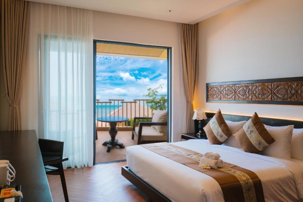 a bedroom with a bed with a teddy bear on it at Pandora Beach Mui Ne Retreat in Mui Ne