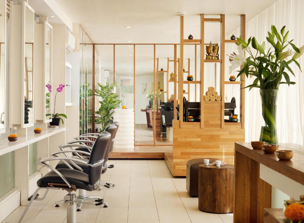 an office with a row of chairs in a lobby at Grandmas Plus Hotel Seminyak in Seminyak