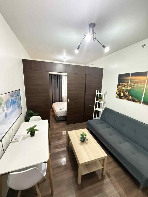 a living room with a couch and a table at Makati One Bed Room with Balcony Air Residence SMDC in Sampong