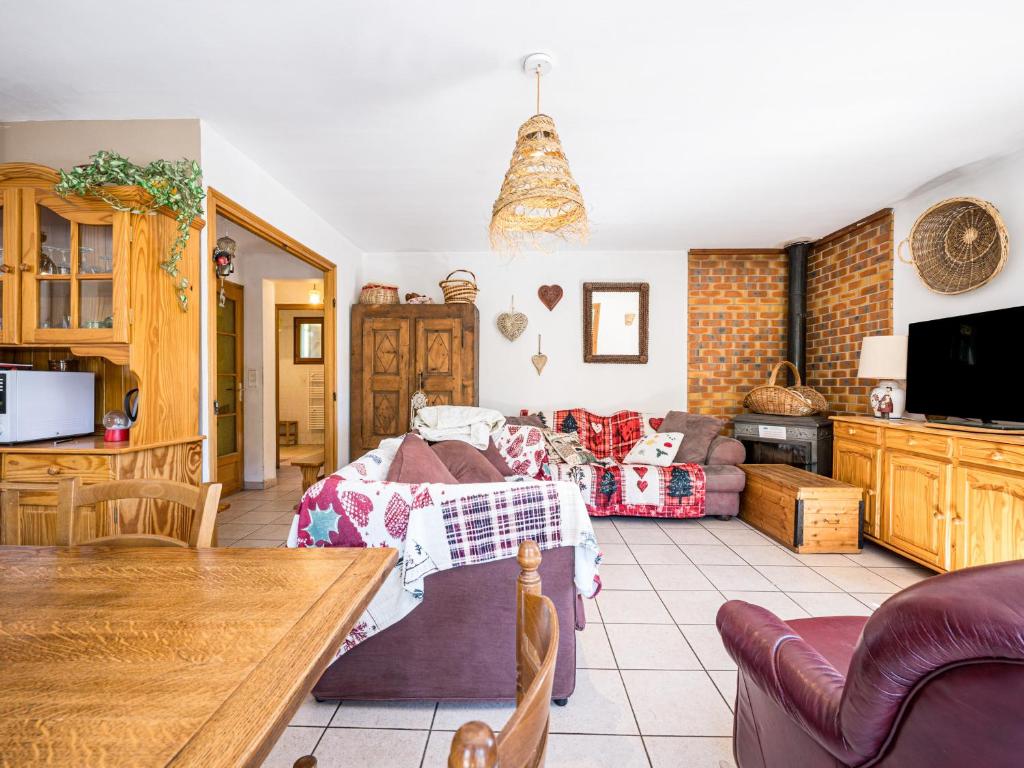 a kitchen and living room with a bed and a table at Les Perdrix Blanches - 5P14 in Saint-Sorlin-dʼArves
