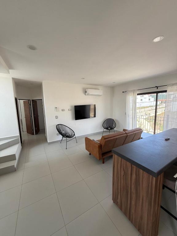 a living room with a couch and a tv at Take A Break in El Suazal