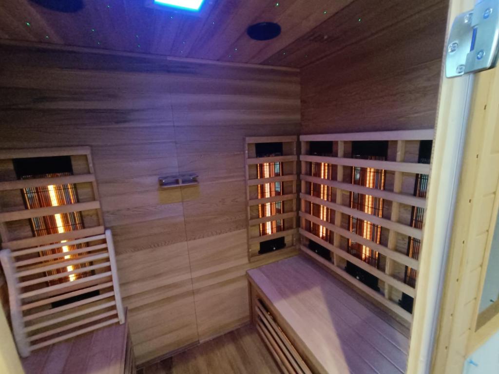 a sauna with wooden walls and a wooden floor at L'écrin des Marais in Les Sables-dʼOlonne