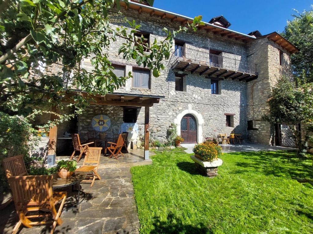 una vista exterior de una casa de piedra con patio en Casa Castan, en Lirí
