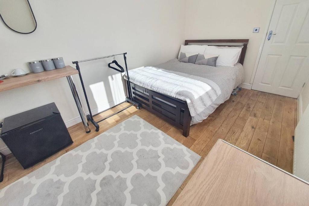 a bedroom with a bed and a rug at Private Guesthouse in Manchester
