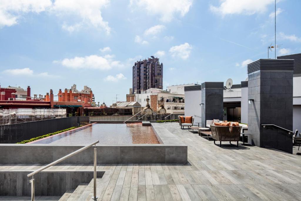 a rooftop deck with a view of a city at Midtown Apartments in Barcelona