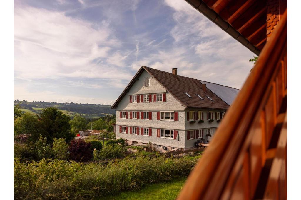a large house on top of a green field at Ferienhof Sinz im Allgäu in Weiler-Simmerberg